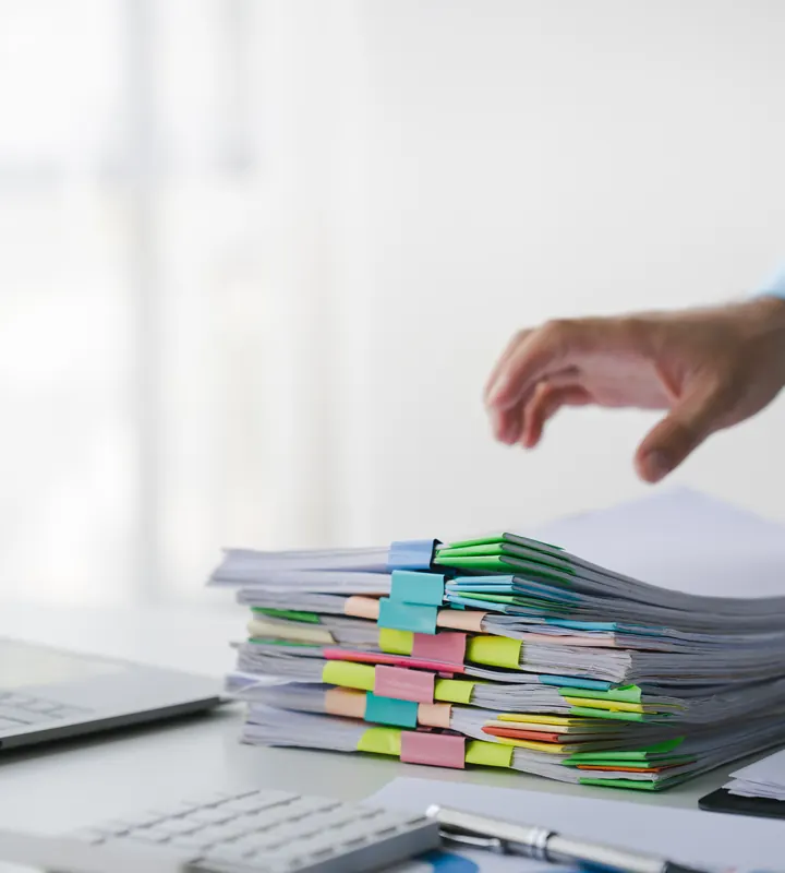 Stacks of case documents and a laptop for records review